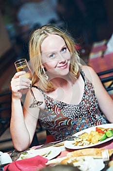 Woman with glass of wine in restaurant