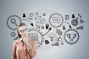 Woman in glasses and business prize, gray wall