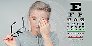 Woman in glasses. Eye test. Eyesight vision exam chart