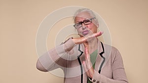 Woman in glasses in glasses doing time out gesture with hands, frustrated and serious face