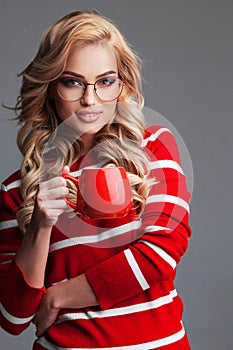 Woman in glasses holding red cup