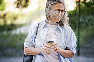 Woman With Glasses Looking at Cell Phone