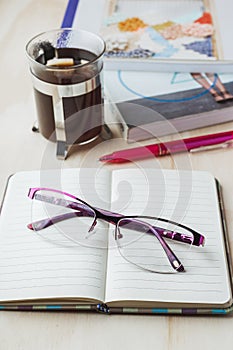 Woman glasses with notebook, coffee, pencil and book