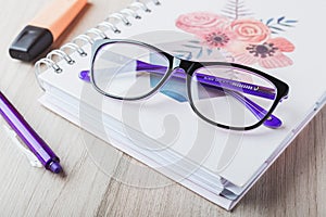 Woman glasses with planner and pencils