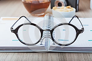 Woman glasses with planner, tea and camera