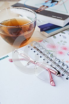 Woman glasses with tea and books