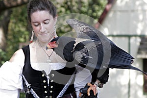 Woman in glove holding a large bird of prey