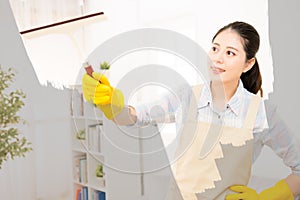 Woman in gloves cleaning window