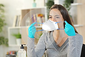 Woman with gloves putting mask avoiding at home