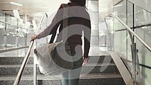 Woman go up on stairs at international airport