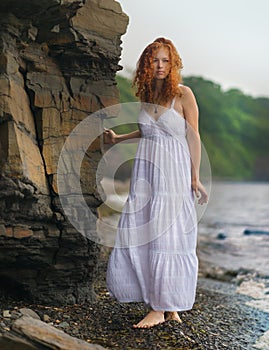 Woman goes along the coast.