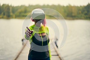 Woman goes into virtual reality using virtual reality headset.