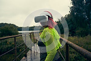 Woman goes into virtual reality using virtual reality headset.