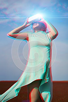 Woman goes into virtual reality using virtual reality headset. Image with glitch effect.
