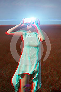 Woman goes into virtual reality using virtual reality headset. Image with glitch effect.