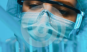 Woman in goggles and mask working