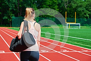 Woman going on fitness training with sport bag