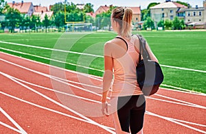 Woman going on fitness training with sport bag