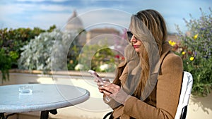 Woman going through her phone, sitting a