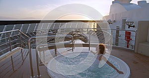 Woman Going In Hot Tub Jacuzzi Spa At With Amazing Sunrise sea View.