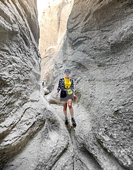 Woman going through pass between heigh mountains