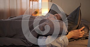 Woman going to sleep on bed at home