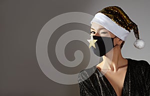 Woman with gold christmas hat, black medical mask. Fashion shiny style for xmas time. Protection from flu on holidays