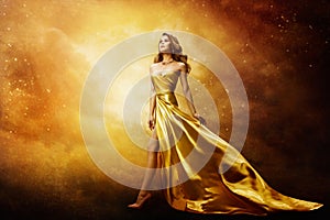 Woman in Gold Dress Looking to Space Stars, Beautiful Fashion Model on Golden Sky