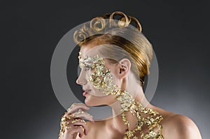 Woman with gold makeup