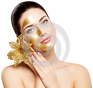 Woman Gold Mask, Beautiful Model Golden Facial Skin Cosmetic, Colored Half Face, Beauty Skincare and Treatment photo