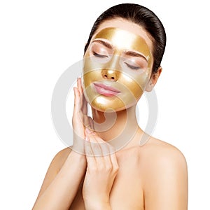Woman Gold Mask, Beautiful Model with Golden Skin Cosmetic touch Face, Beauty Skincare and Treatment photo
