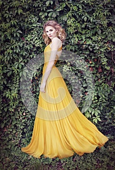 Woman in golden dress, in nature