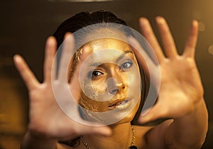 Woman with golden makeup and bodyart