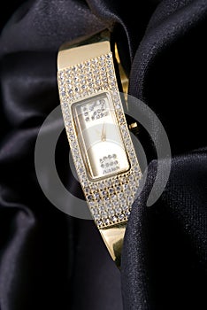 Woman golden watch with crystals