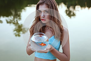 Woman with a goldfish.