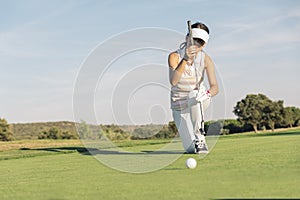 Woman golf player concentrating.