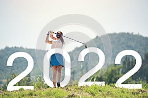 Woman golfer finished golf swing. Beginning and start of the new year 2022, goals and plans for the next year