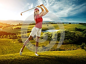 Woman golfer hitting the ball on the background scenery beautiful