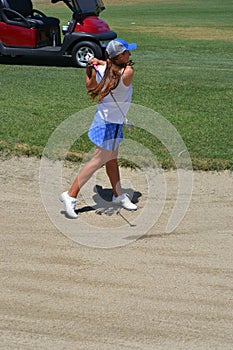 Woman Golfer Hitting Out of Sand