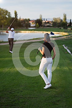 Woman golfer waiting her turn to tee of photo