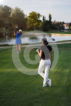 Woman golfer waiting her turn to tee of photo