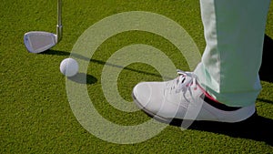 Woman golfer wearing golfing shoes
