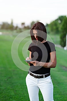 Woman golfer writing on score card on golf course