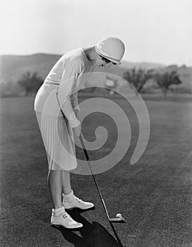 Woman golfing