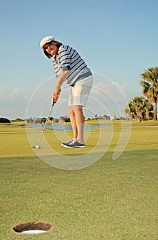 Senior Woman golfing