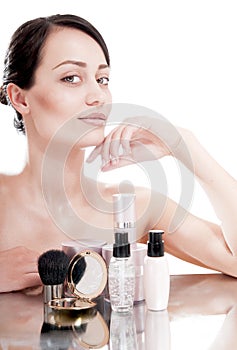 Woman with a good complexion near the creams cosmetics. Skin car