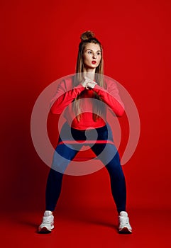 Woman with good physique doing stretching work out with elastic bands.