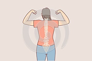 Woman with good posture and straight spine shows biceps, standing with back to camera