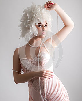 Woman in Gorgeous Wig Playing With Pearls