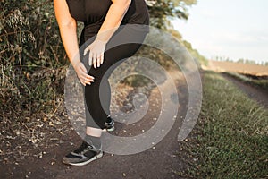 Woman got a knee trauma at outdoor jogging